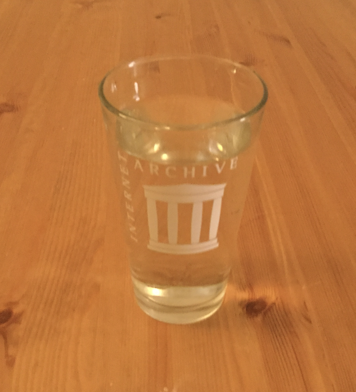 image of a tall pint glass full of water where the water appears very vertical